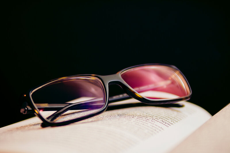 glasses on an open book