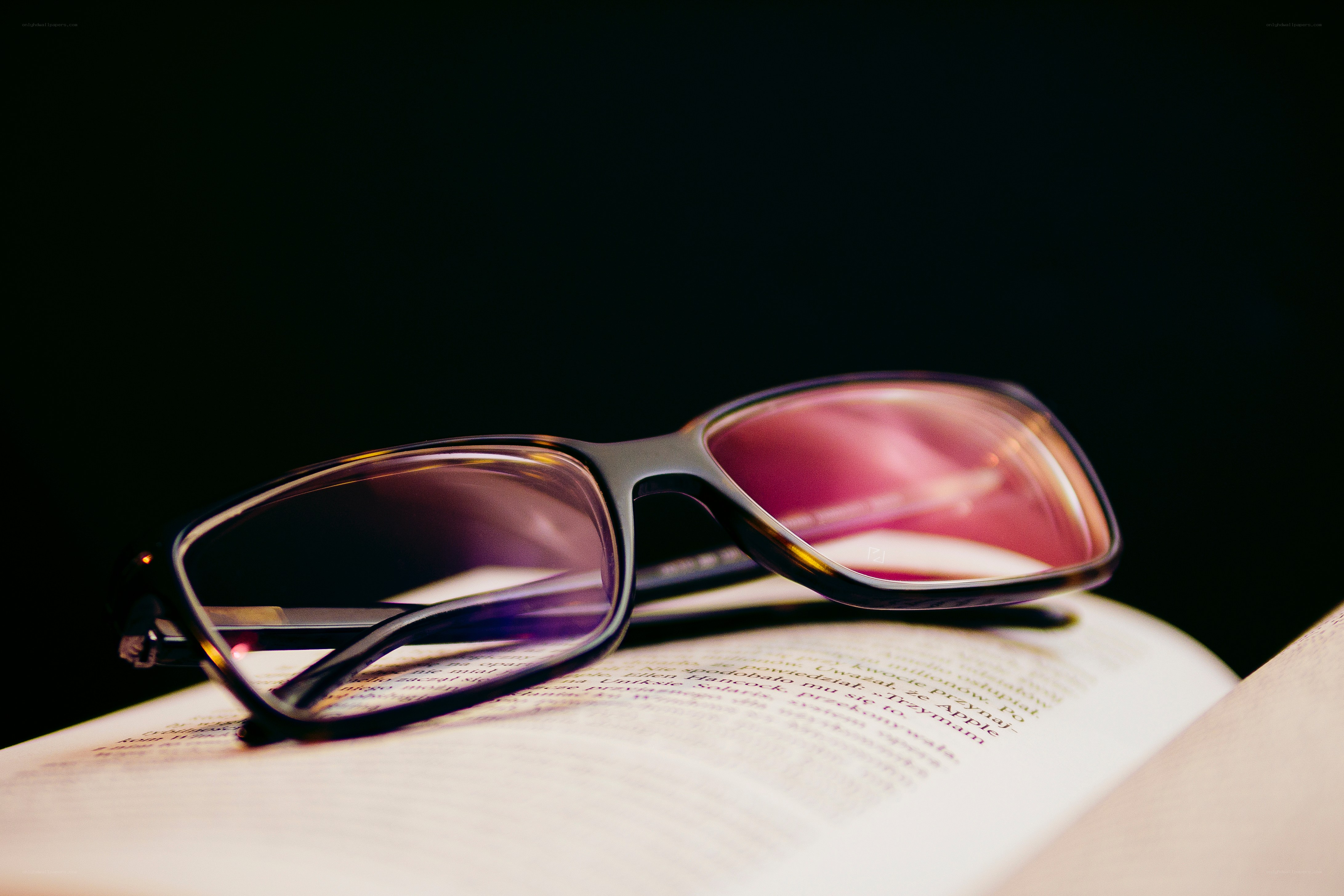 glasses on an open book