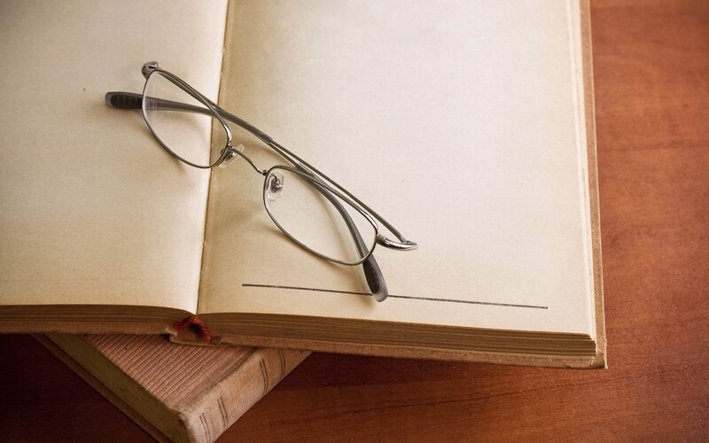 glasses on open book