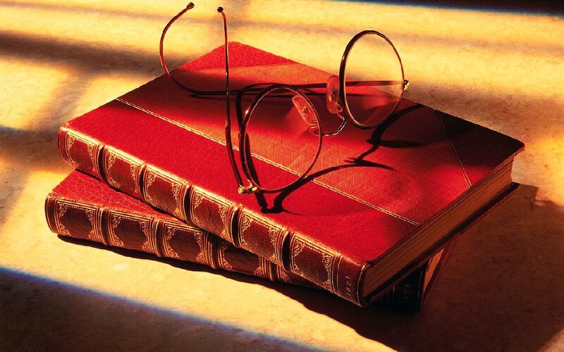 glasses on red books
