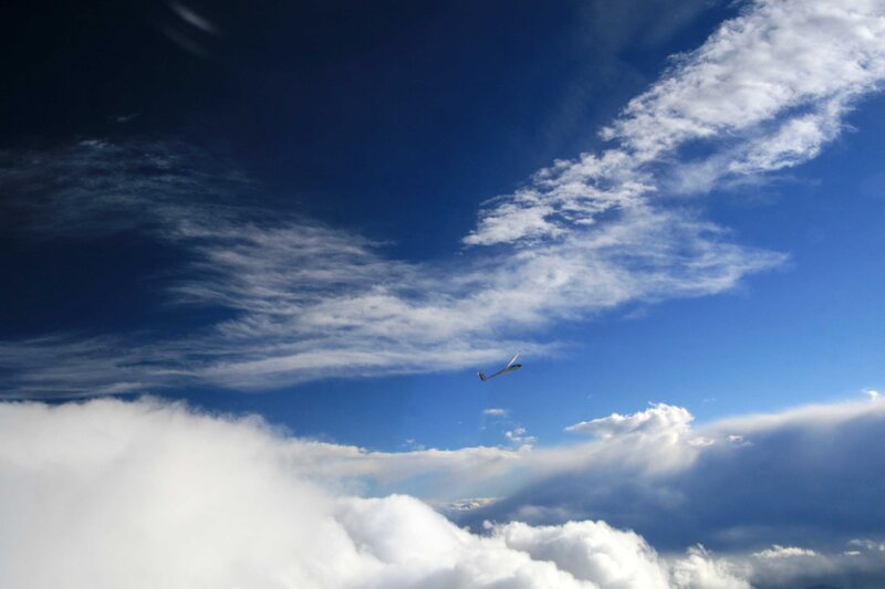 glider above the clouds