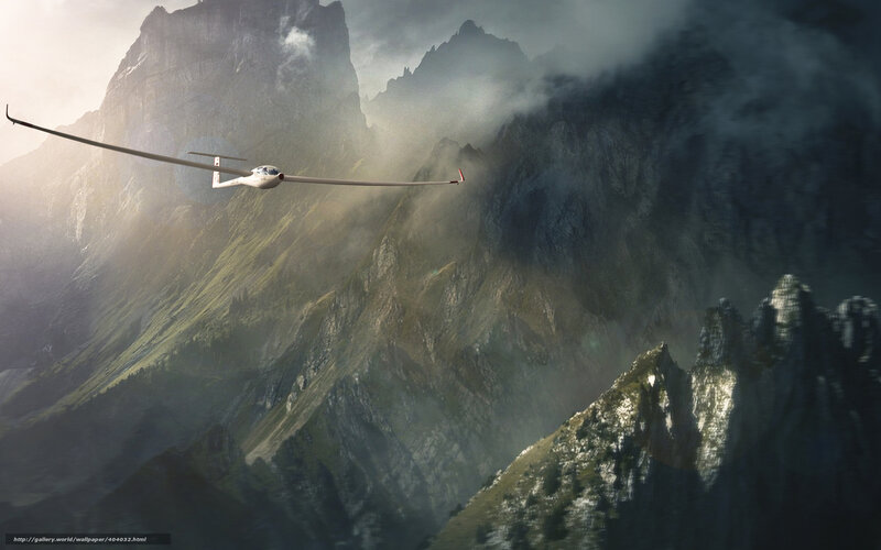 glider flying over mountains