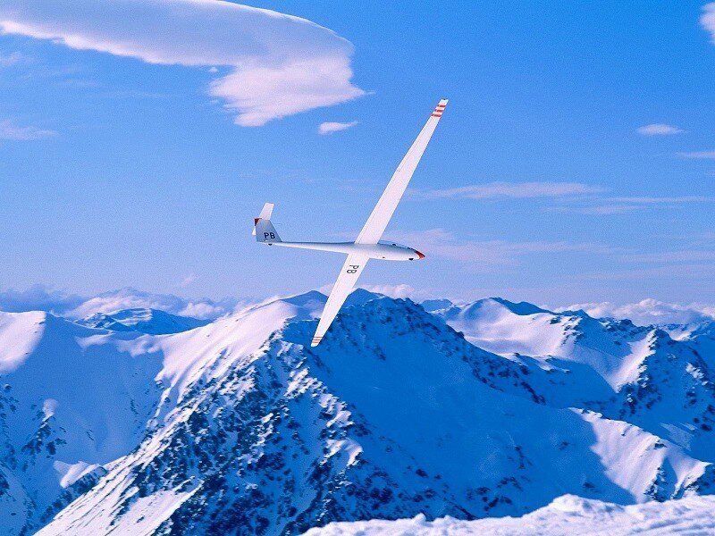 Glider over snowy mountains