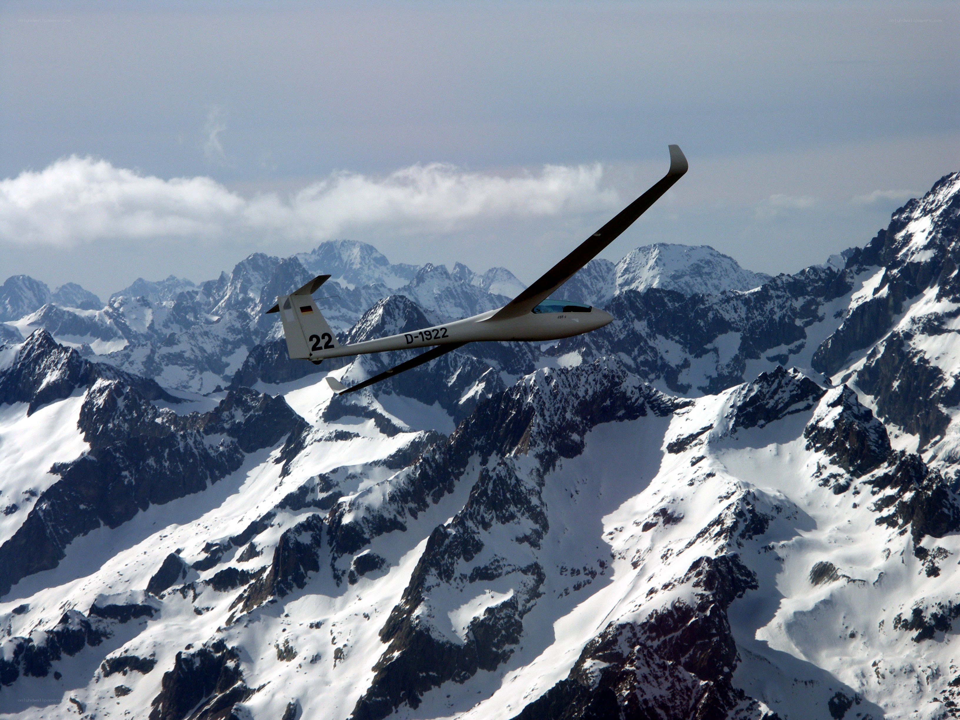 glider over snowy mountains