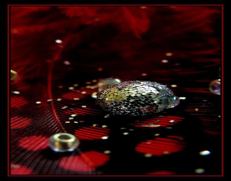 Glittery bead on red feather