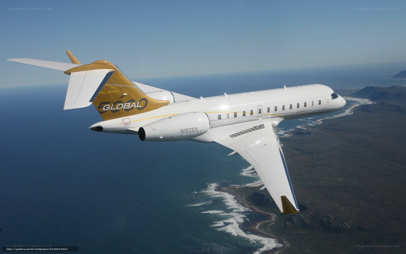 Global 5000 jet over coastline