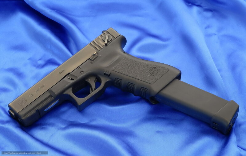Glock 18 pistol on blue cloth