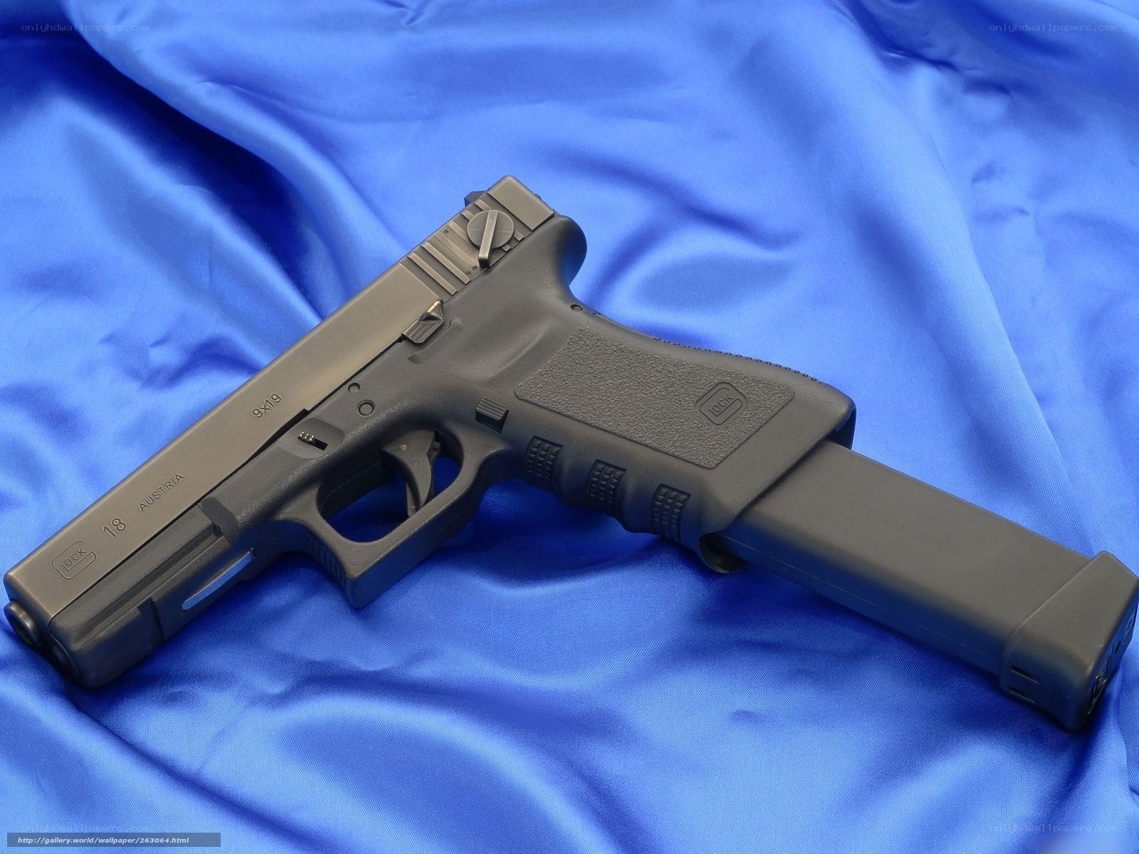 Glock 18 pistol on blue cloth