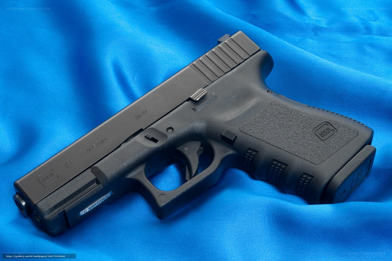 Glock 19 pistol on blue fabric