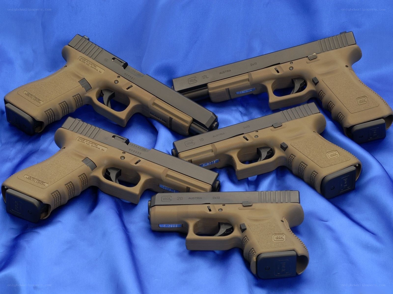 Glock pistols on blue cloth