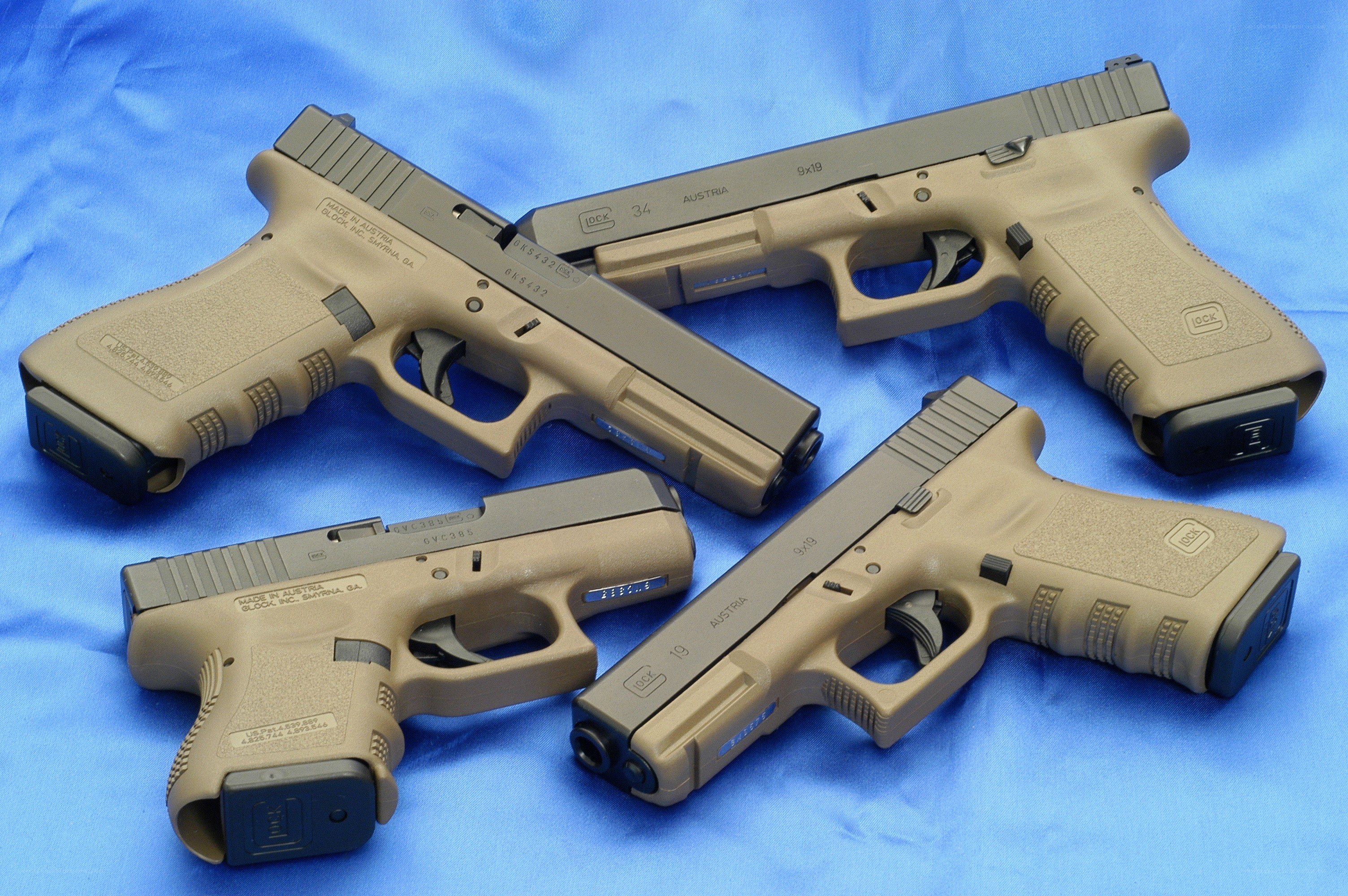 Glock pistols on blue cloth