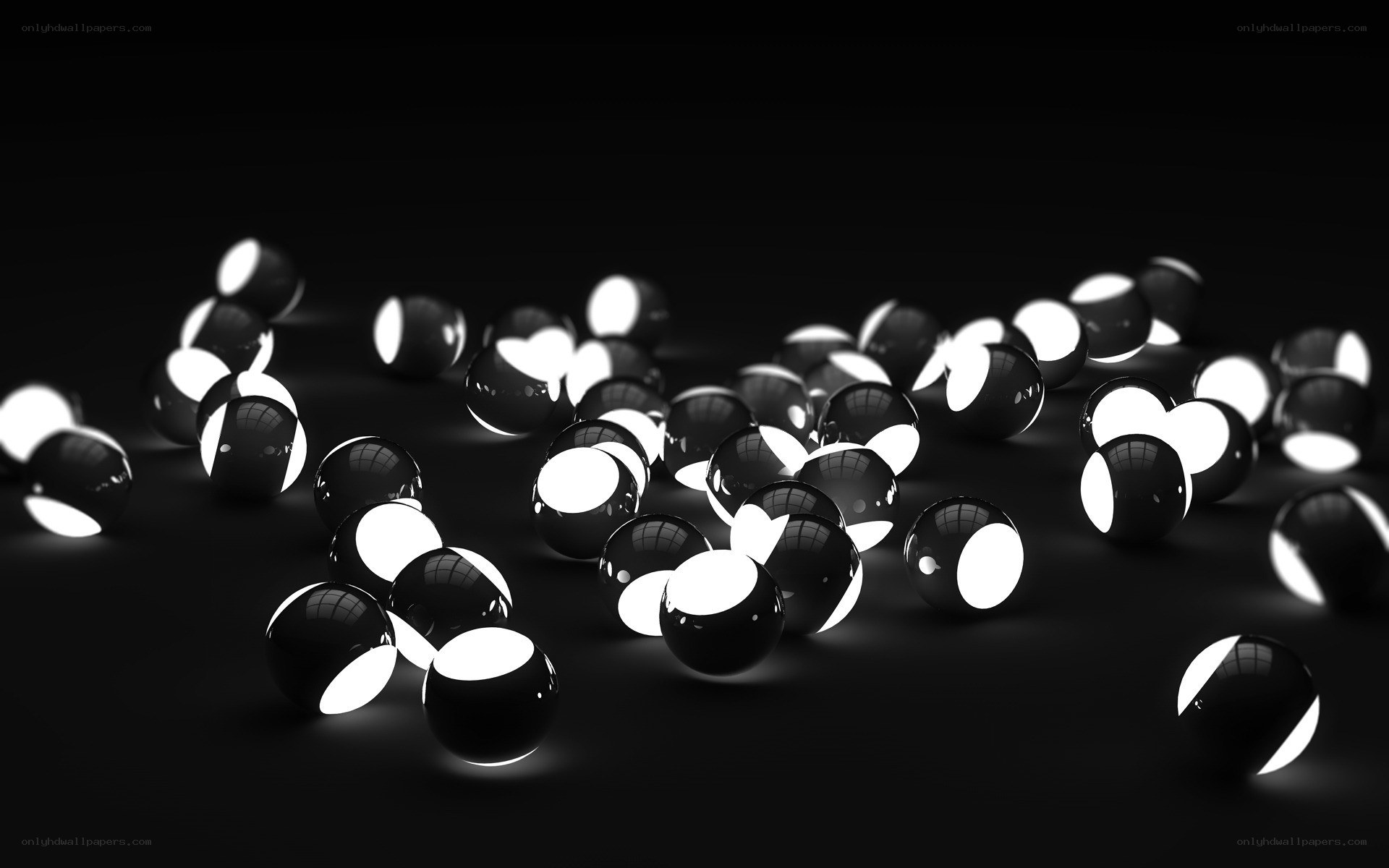 Glossy black spheres on dark surface