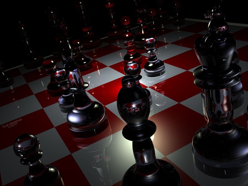 Glossy chess pieces on red board