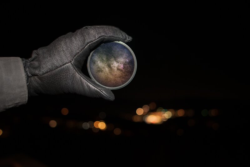 Gloved Hand Holding Lens