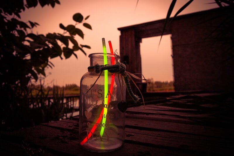 glow sticks in a jar at sunset