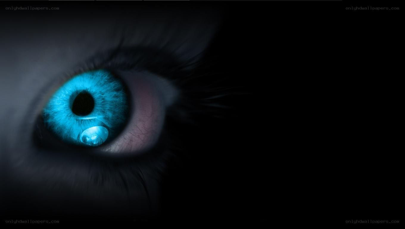 glowing blue eye in darkness