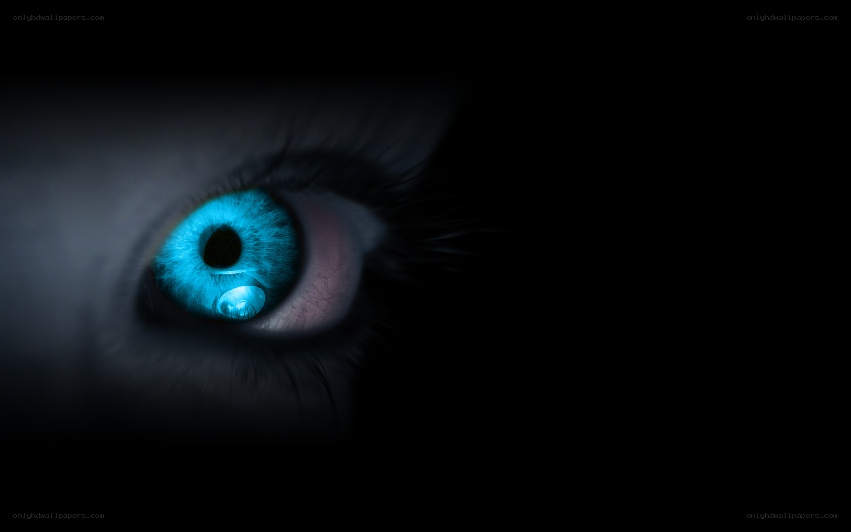 glowing blue eye in darkness