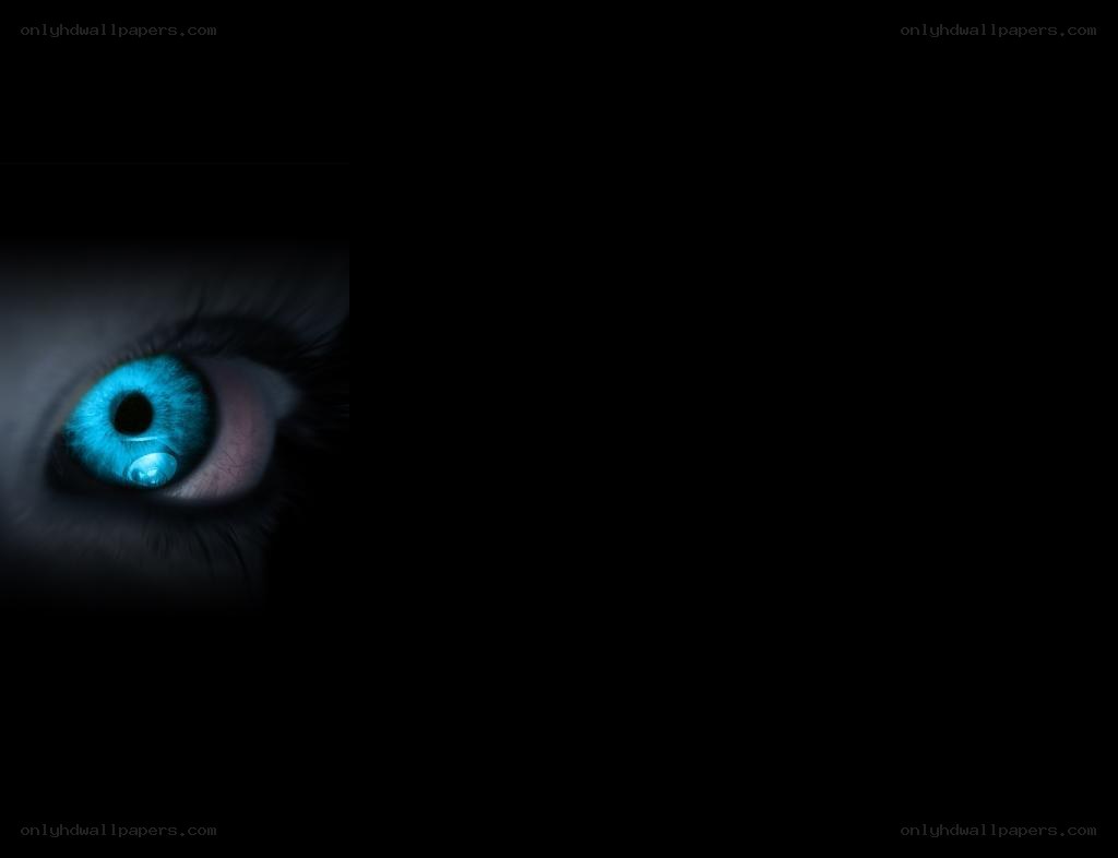 glowing blue eye in darkness