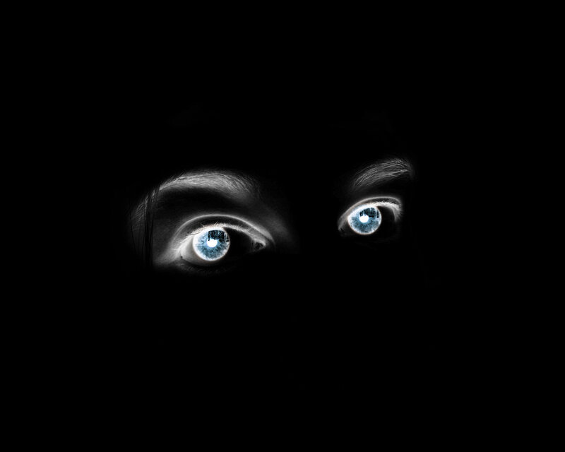 glowing blue eyes in darkness