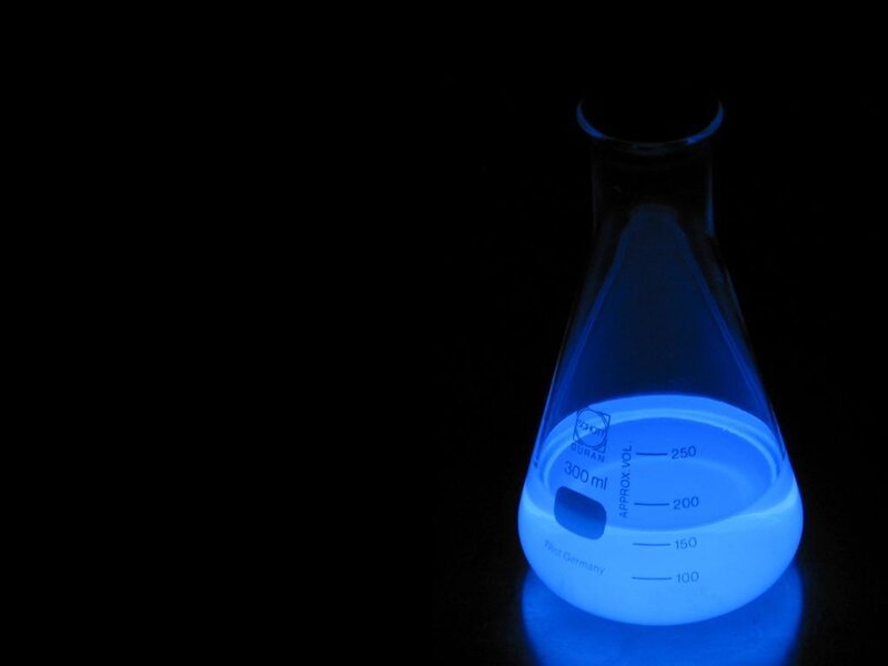 glowing blue liquid in flask