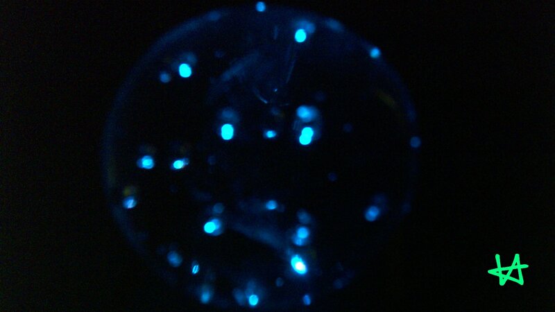 glowing blue sphere with green mark