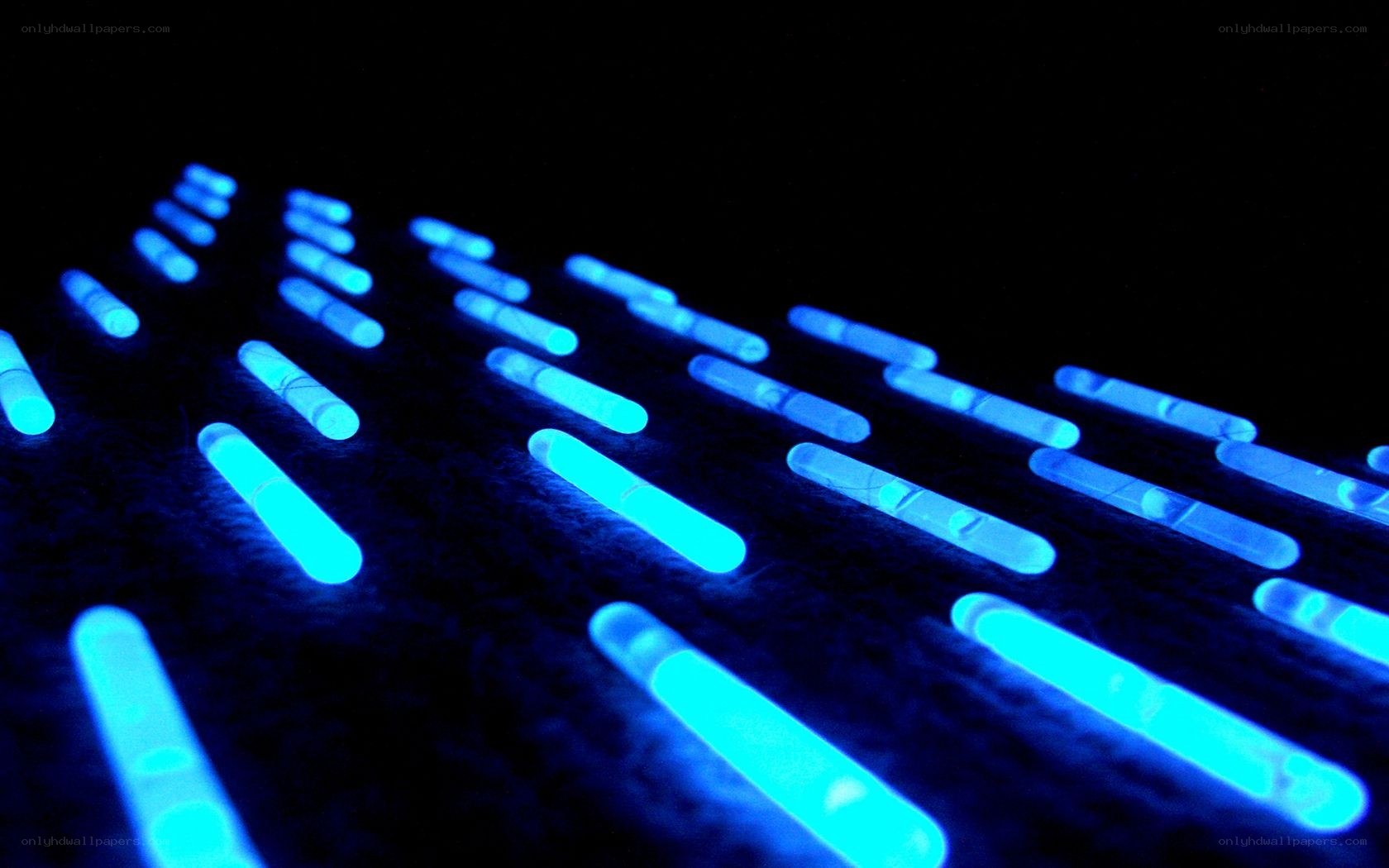 glowing blue sticks on dark surface