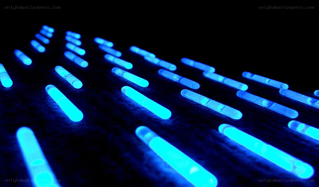 glowing blue sticks on dark surface