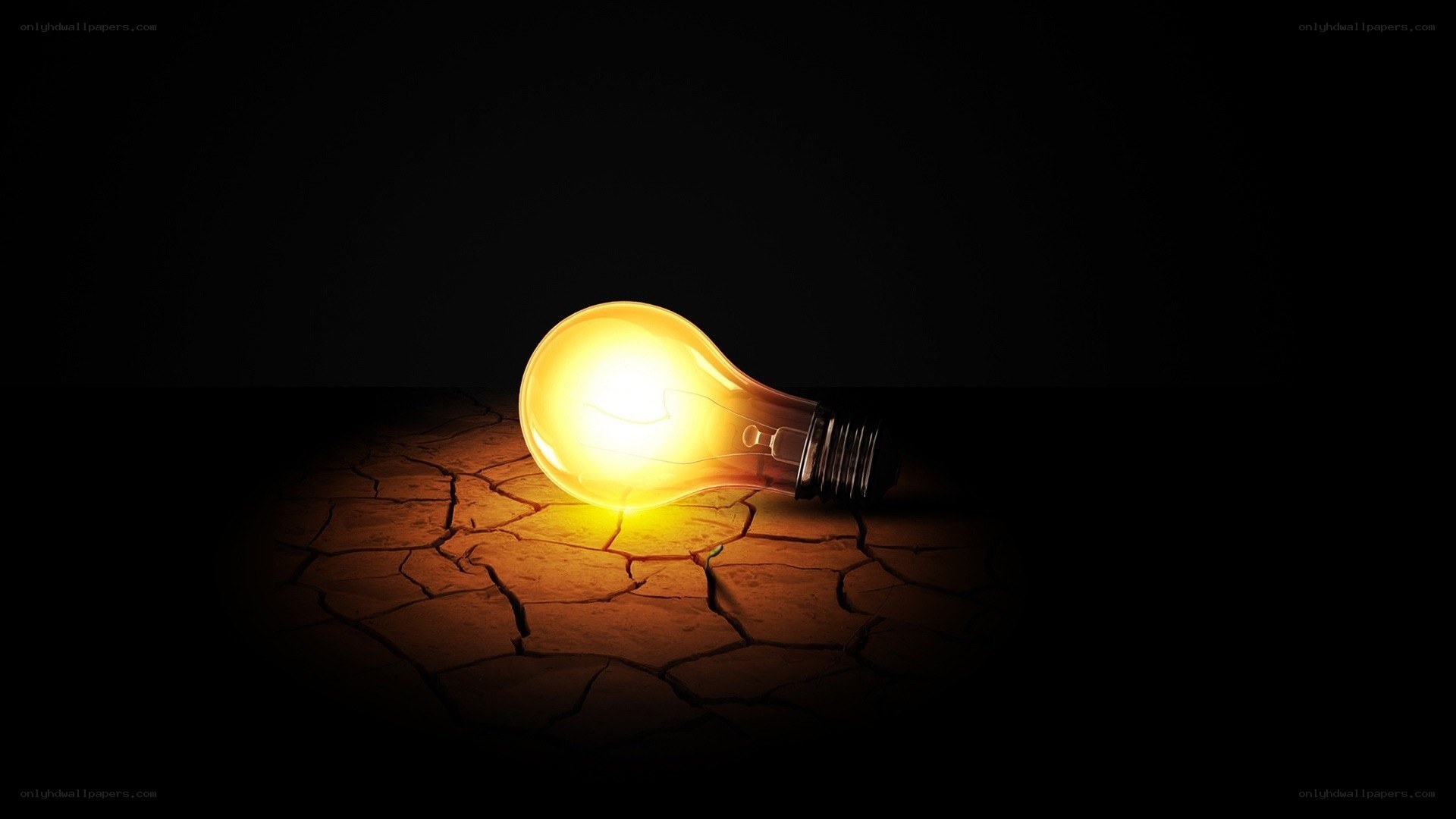 glowing bulb on cracked earth