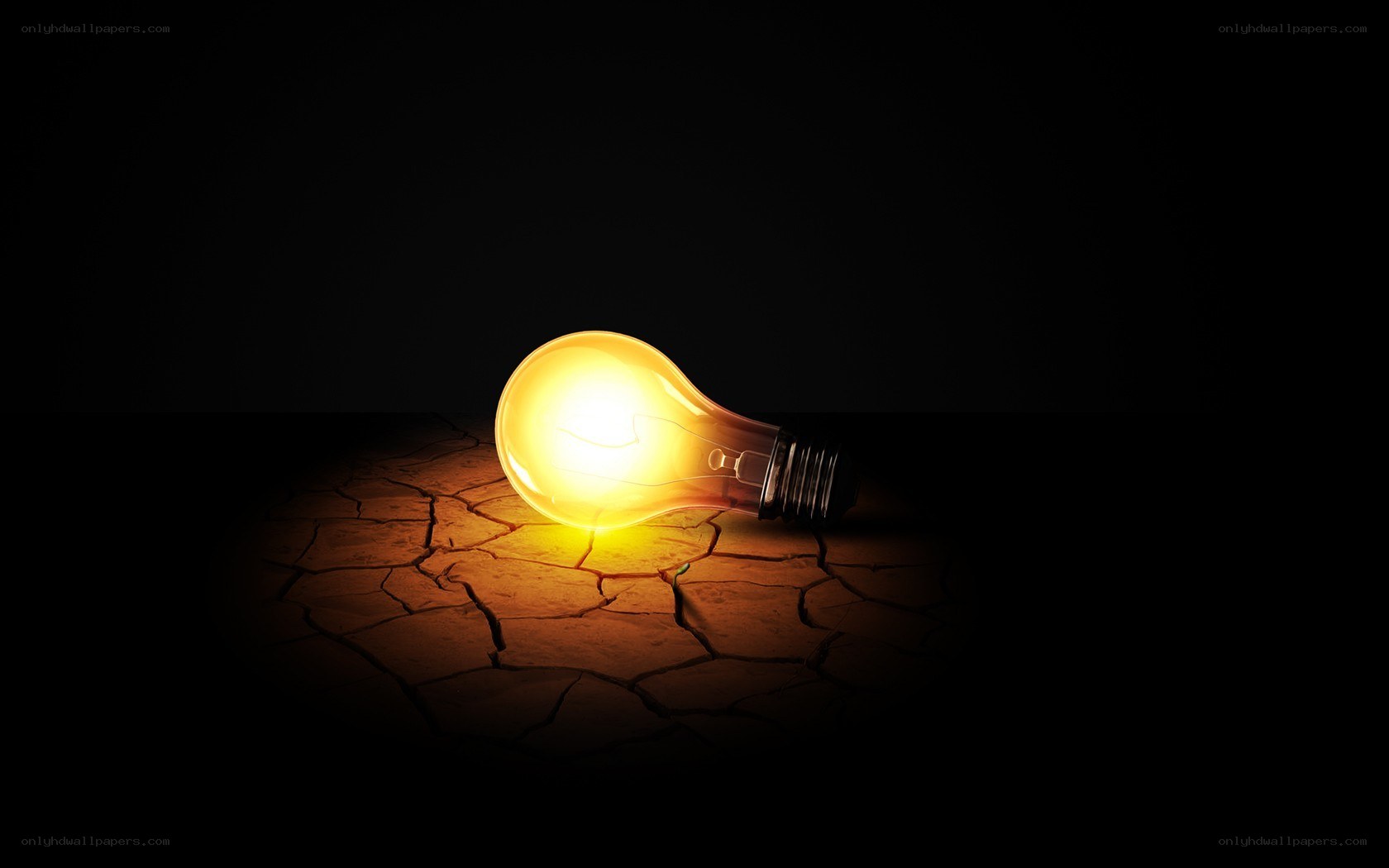 glowing bulb on cracked earth