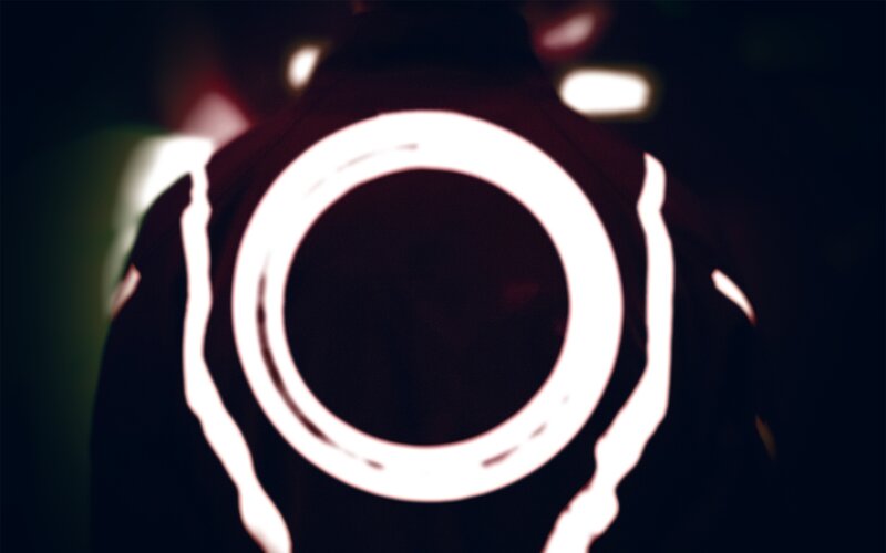 glowing circle on dark jacket