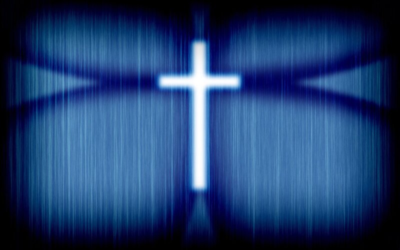 glowing cross on blue background