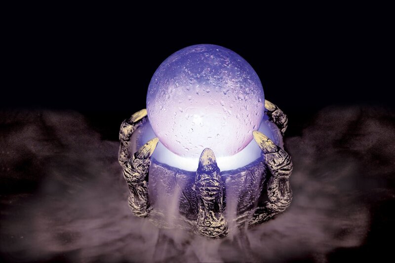 glowing crystal ball in clawed hands