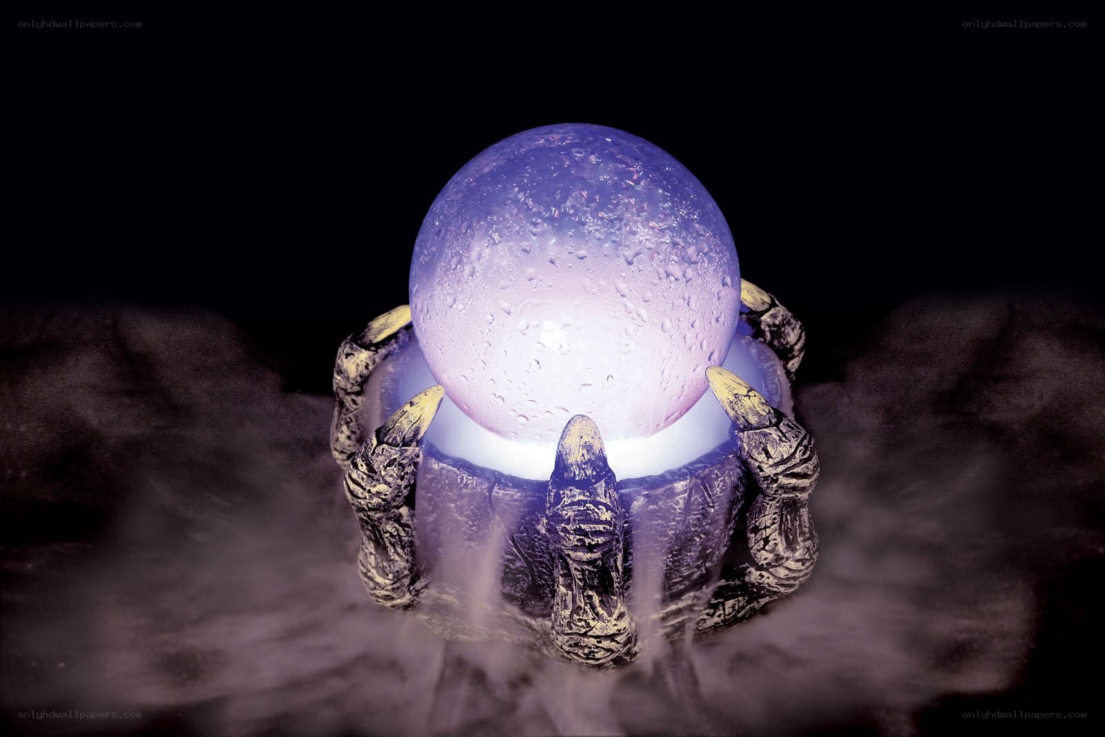 glowing crystal ball in clawed hands