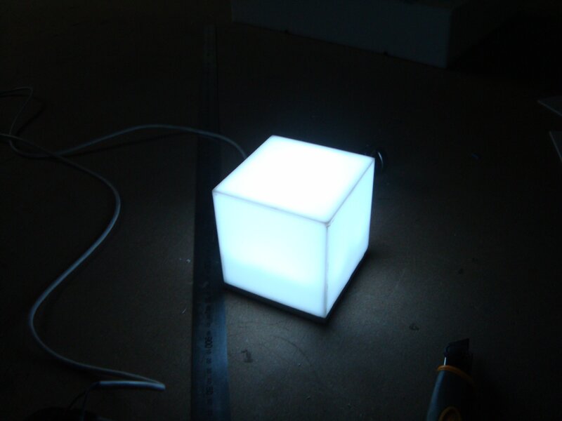 glowing cube on dark surface