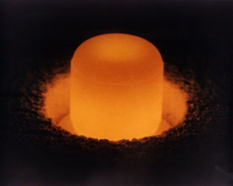 Glowing cylinder in dark chamber