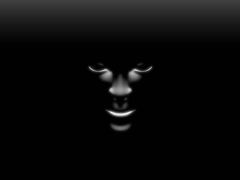 glowing face in darkness