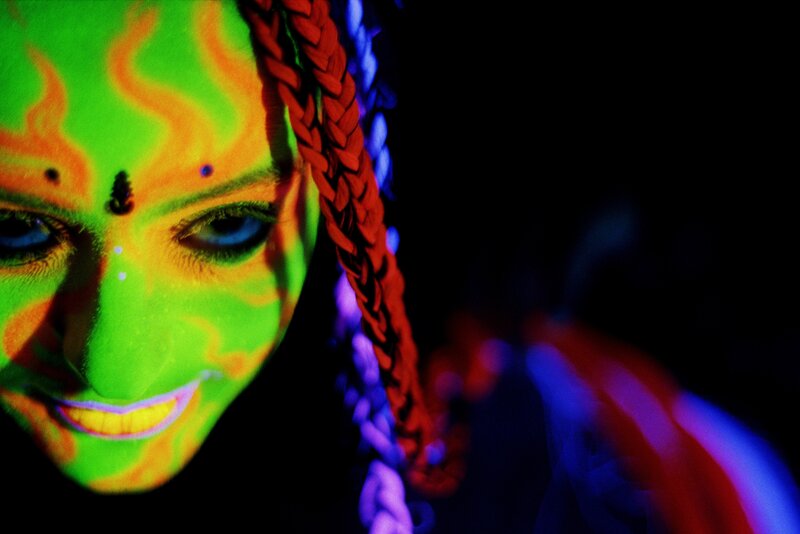 glowing face under blacklight