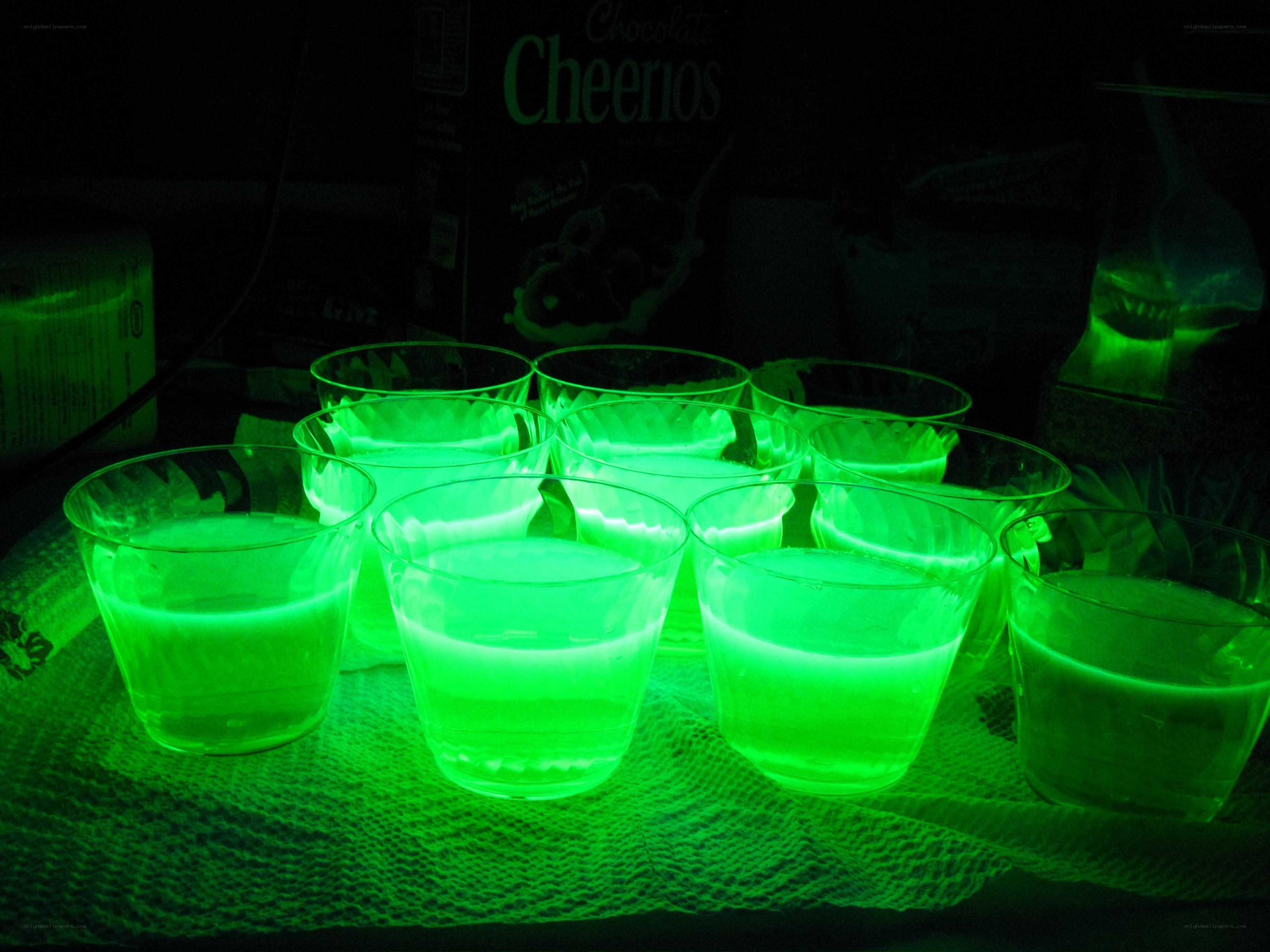 Glowing green cups under black light