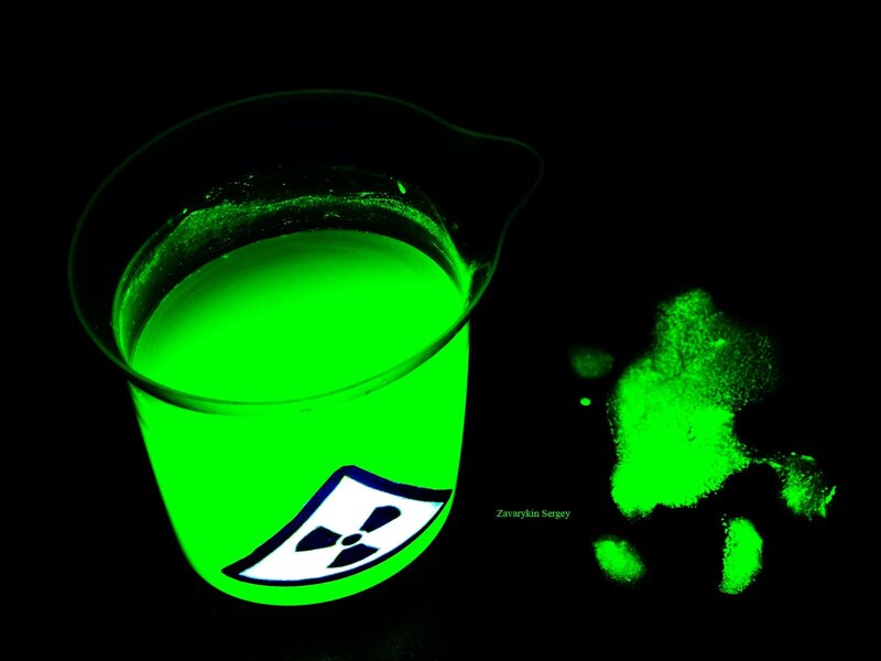 glowing green liquid in beaker