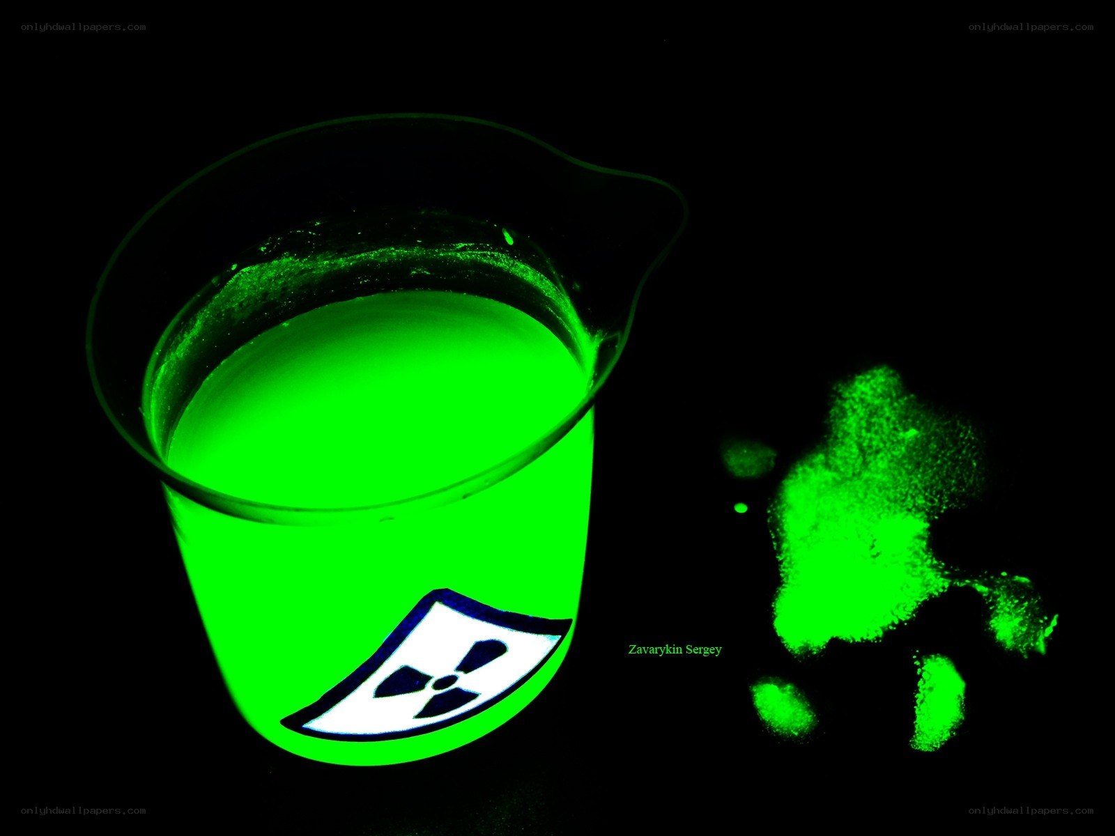 glowing green liquid in beaker