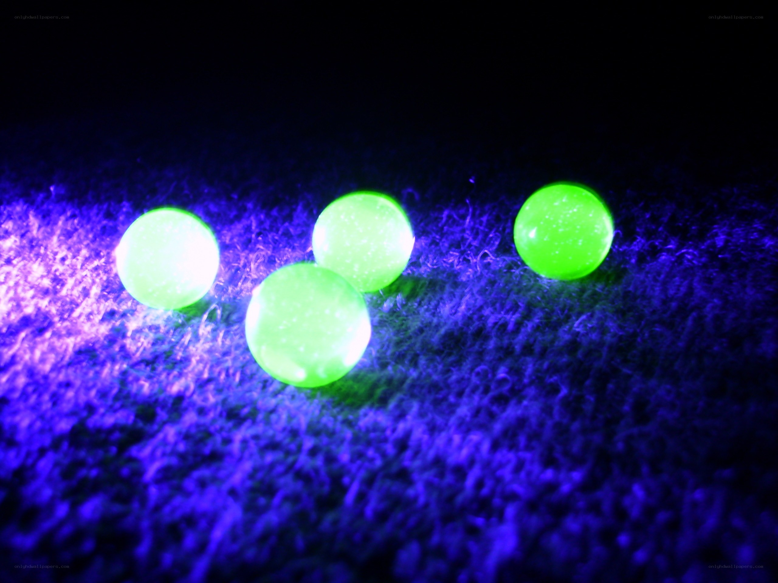 glowing green marbles on fabric