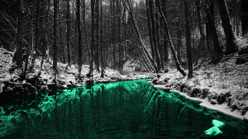 glowing green stream in snowy forest