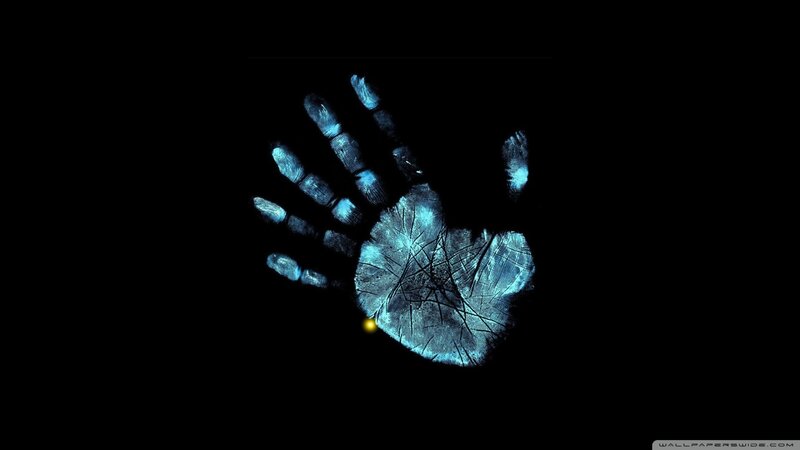 glowing handprint on black
