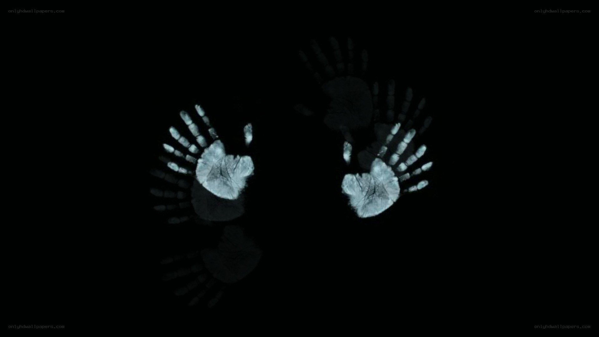 glowing handprints in darkness