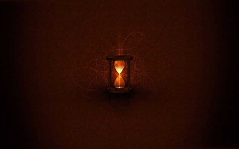 glowing hourglass in darkness