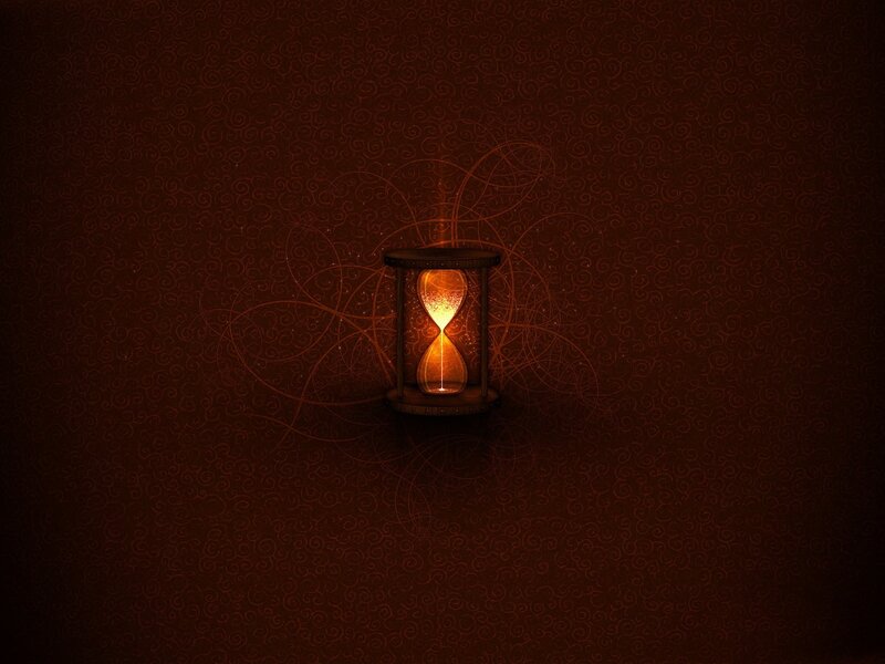 glowing hourglass on dark background