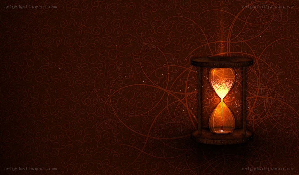 glowing hourglass on patterned wall