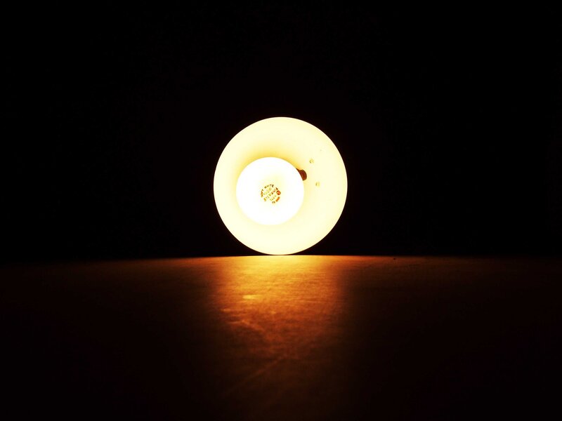 glowing lamp on dark surface