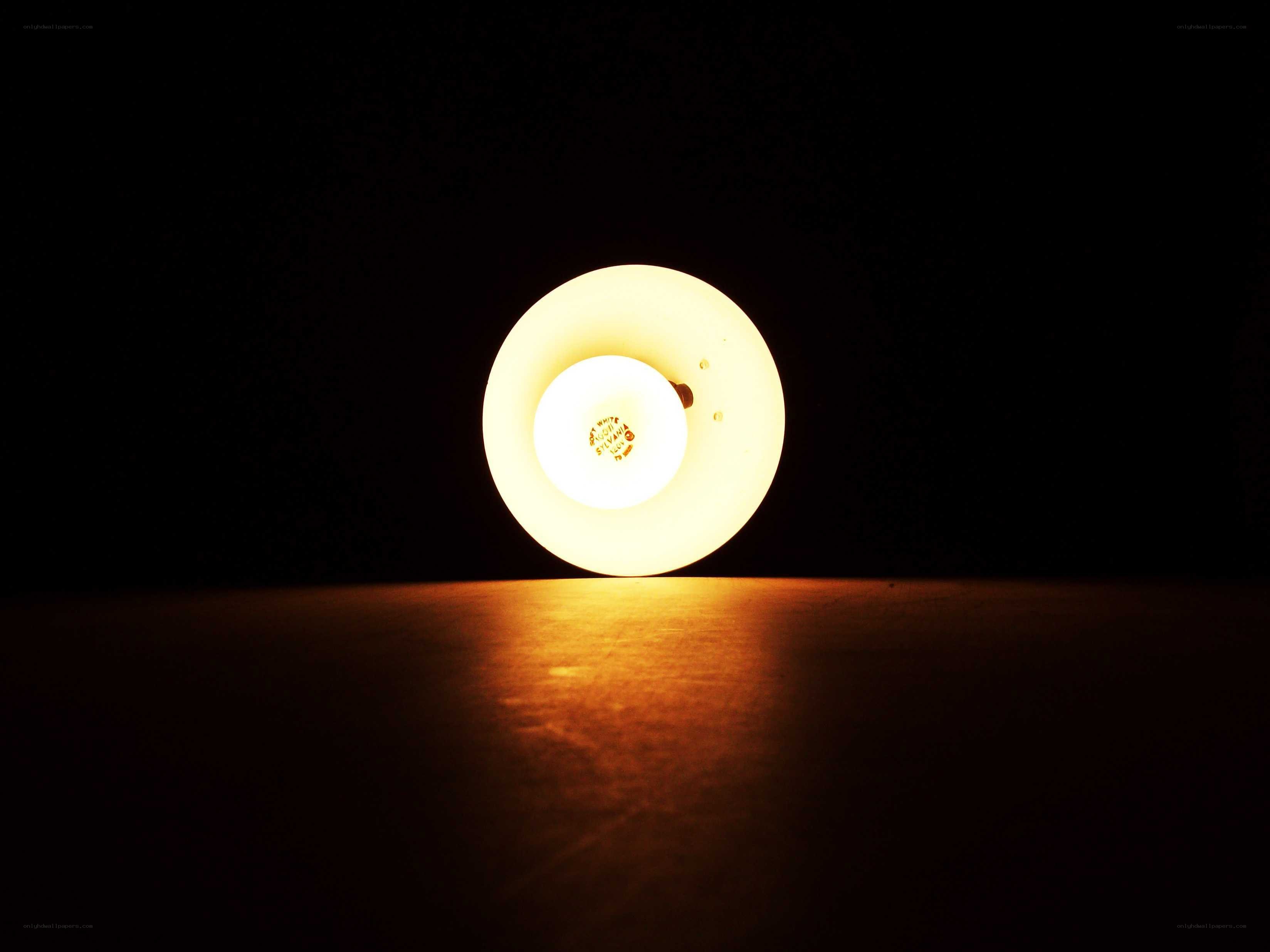 glowing lamp on dark surface
