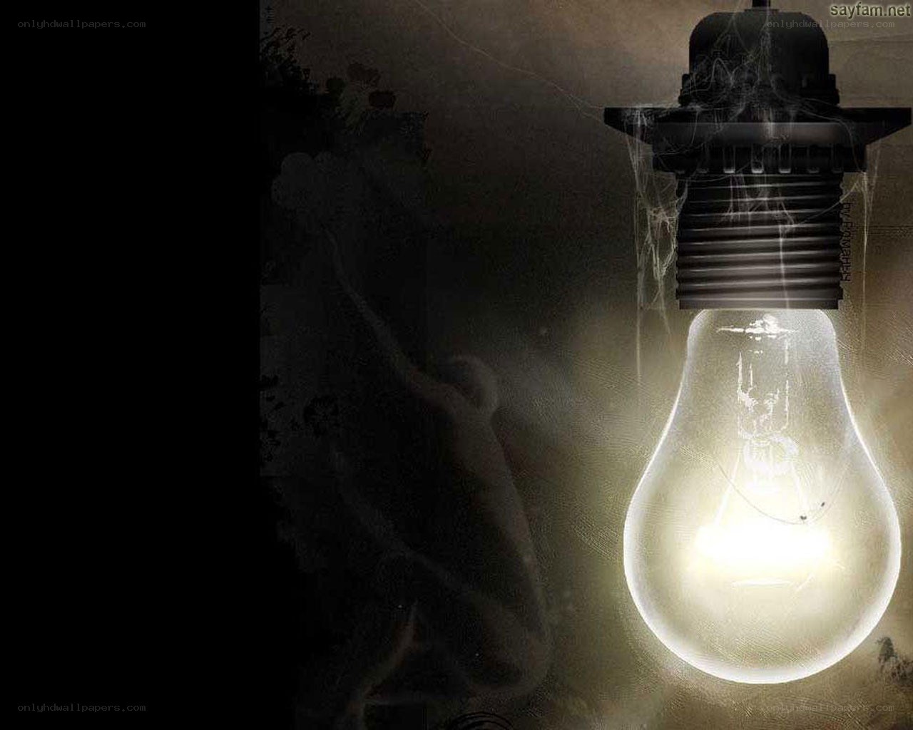 glowing light bulb in dark room
